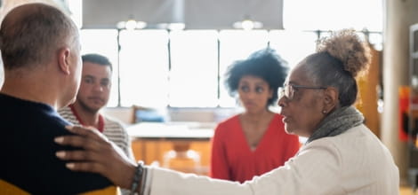 Senior woman comforting mature man